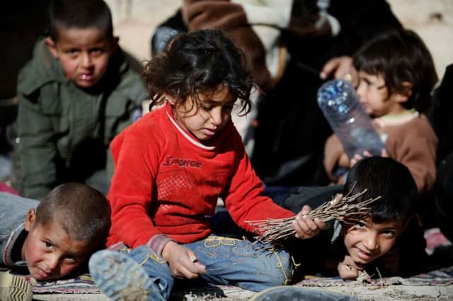 Syrian children take temporary refuge in Akcakale, a dusty Turkish border town. Picture: Getty