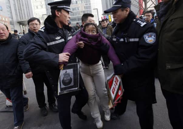 Liu Chunxia is seized by police. Picture: Reuters
