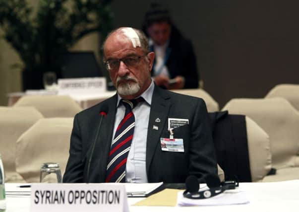 Syrian opposition member Haitham al-Maleh sits alone during the Geneva-2 peace conference in Montreux. Picture: Reuters
