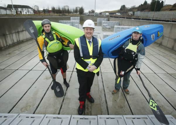 Keith BrownMSP with Tom Brown (left) and Mark Mulrain (right) at Pinkston Paddlesports. Picture: PA