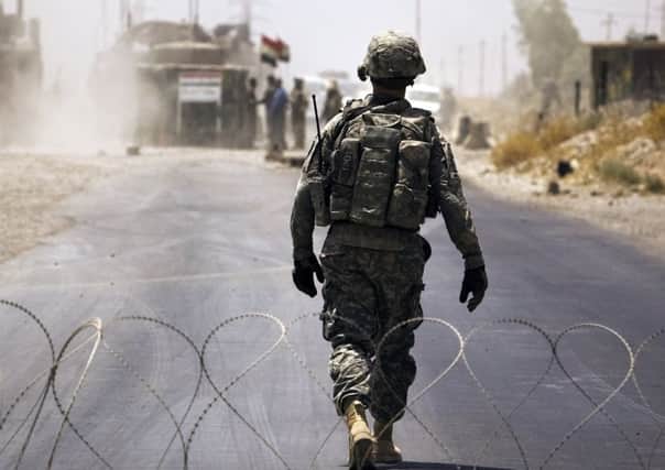 A US soldier walks through a flash checkpoint in Ali Ayun, Diyala Province, Iraq in 2010. Picture: Getty