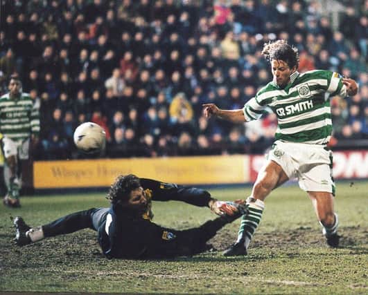 Jorge Cadete of Celtic lifts the ball over the head of Hearts goalkeeper Gilles Rousset. Picture: TSPL
