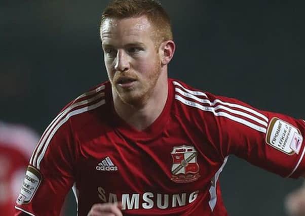 Adam Rooney, pictured here playing for Swindon, has signed a two-and-a-half year deal with the Dons. Picture: Getty