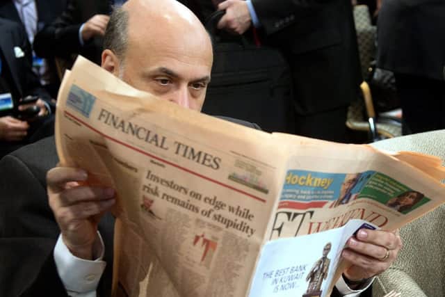 US Federal Reserve Chairman Ben Bernanke reads the Financial Times at an IMF meeting. Picture: Getty