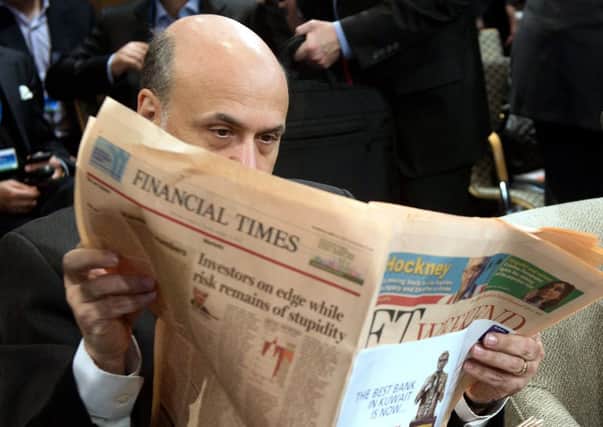 US Federal Reserve Chairman Ben Bernanke reads the Financial Times at an IMF meeting. Picture: Getty