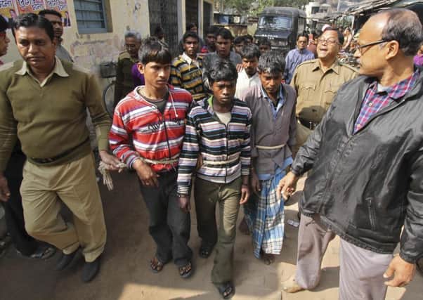 Indian police personnel escort men accused of a gang-rape to a court at Birbhum district in West Bengal. Picture: Reuters