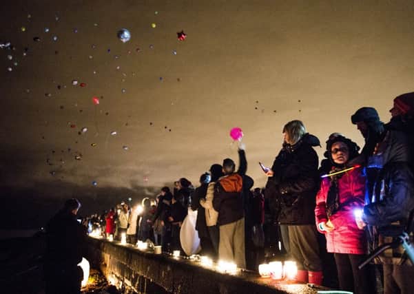 Balloons and lanterns were released at Ravenscraig Beach in tribute to Mikaeel Kular. Picture: Ian Georgeson