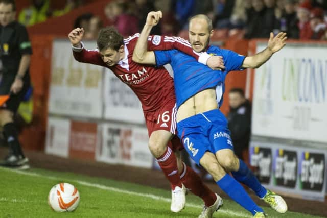 Aberdeen's Peter Pawlett (left) holds off Raven. Picture: SNS