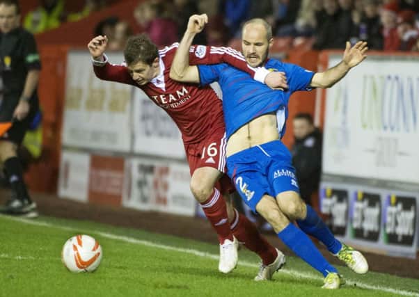 Aberdeen's Peter Pawlett (left) holds off Raven. Picture: SNS