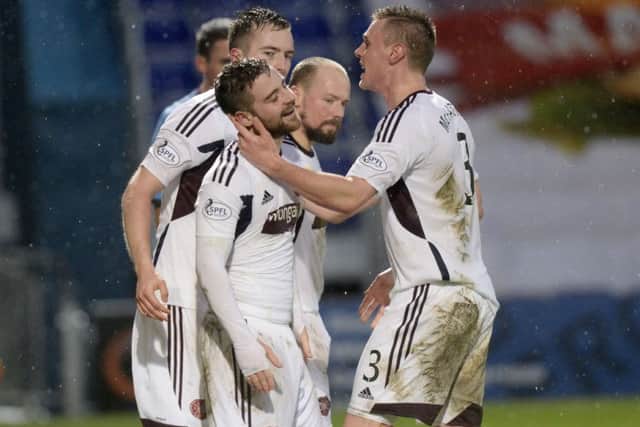 Scott Robinson, left, is mobbed after scoring to give Hearts a 2-1 lead. Picture: SNS