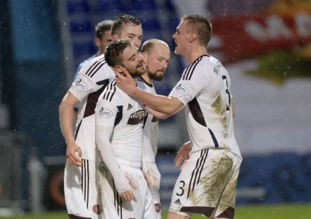 Scott Robinson, left, is mobbed after scoring to give Hearts a 2-1 lead. Picture: SNS