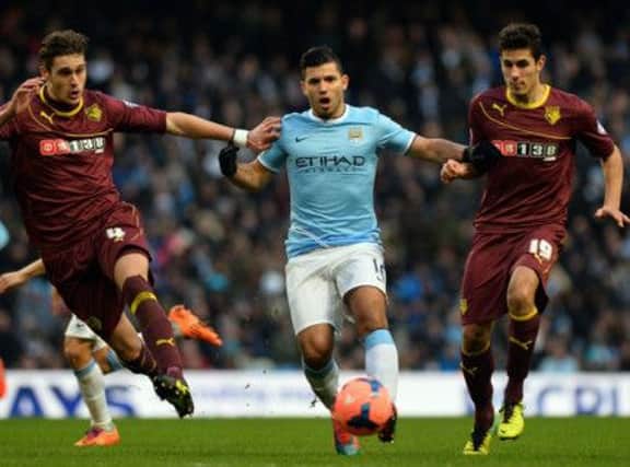 Sergio Aguero is hounded by Watford defenders as he tries to reverse two-goal deficit. Picture: Getty