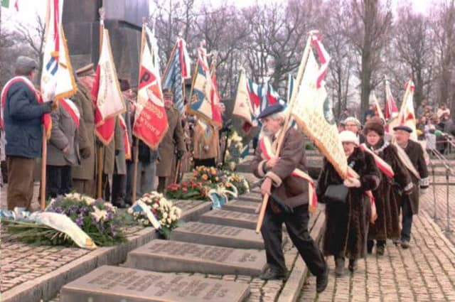 Survivors place flags at the Auschwitz memorial in 1995 on the 50th anniversary of the liberation of the concentration camp. Picture: Getty
