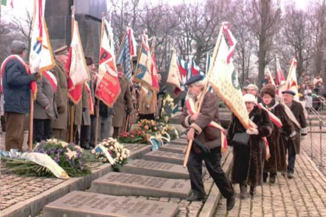 Survivors place flags at the Auschwitz memorial in 1995 on the 50th anniversary of the liberation of the concentration camp. Picture: Getty
