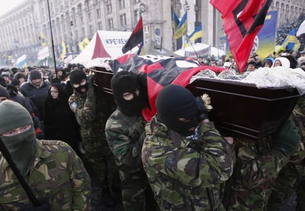 The coffin of an antigovernment protester killed during recent rallies is carried by supporters. Picture: Reuters