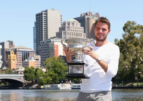Australian Open winner Stanislas Wawrinka poses with the Norman Brookes Challenge Cup in Melbourne. Picture: Getty