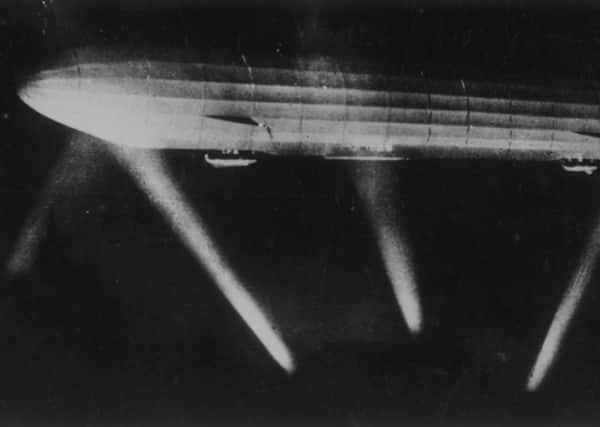 A German Zeppelin is caught in the searchlights during one of the bombing raids which began in Paris on this day in 1916. Picture: Getty