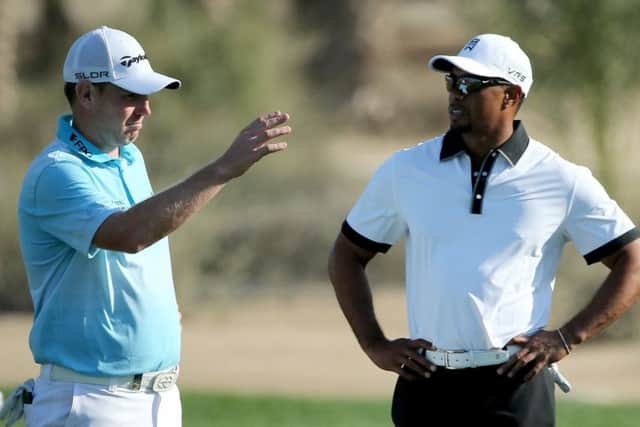 Old opponents Stephen Gallacher, left, and Tiger Woods. Picture: Getty