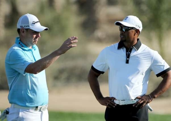 Old opponents Stephen Gallacher, left, and Tiger Woods. Picture: Getty