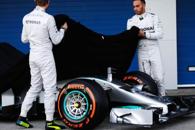 Nico Rosberg and Lewis Hamilton unveil the new Mercedes W05 at Jerez yesterday. Picture: Getty