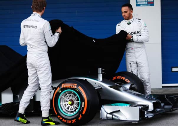 Nico Rosberg and Lewis Hamilton unveil the new Mercedes W05 at Jerez yesterday. Picture: Getty