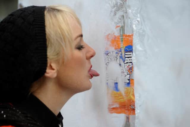 Carolyn Mooney, 26, gets a taste of Irn-Bru's new ice cream, launched today in Glasgow's George Square. Picture: Hemedia