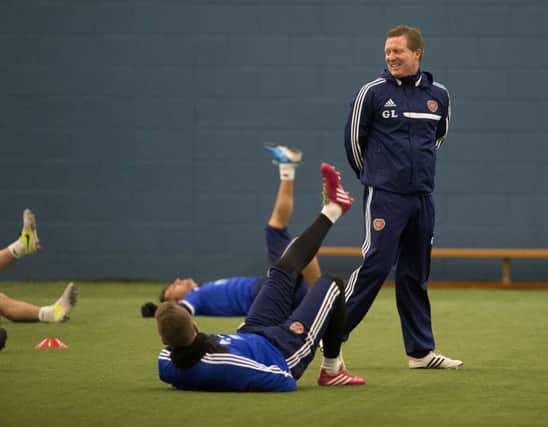 The mood is positive as Hearts manager Gary Locke supervises training yesterday. Picture: SNS