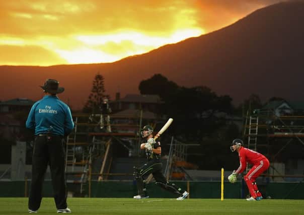 Australias Cameron White targets the short boundary as the sun goes down in Hobart. Picture: Getty