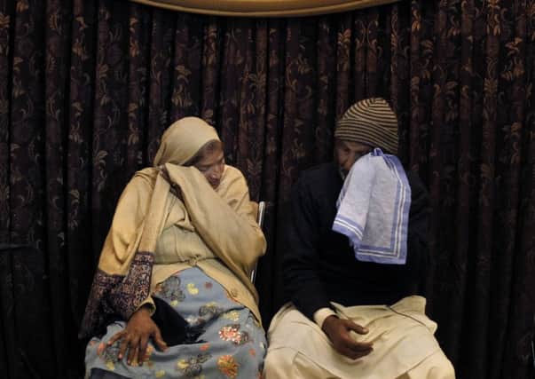 The parents of blasphemy law victim Asif Perai weep. Picture: AP