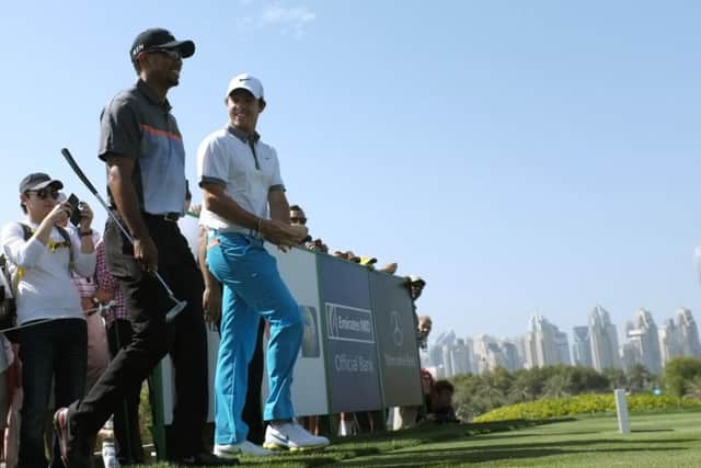Current world No 1 Tiger Woods, left, and Rory McIlroy walk to the eighth tee. Picture: Reuters