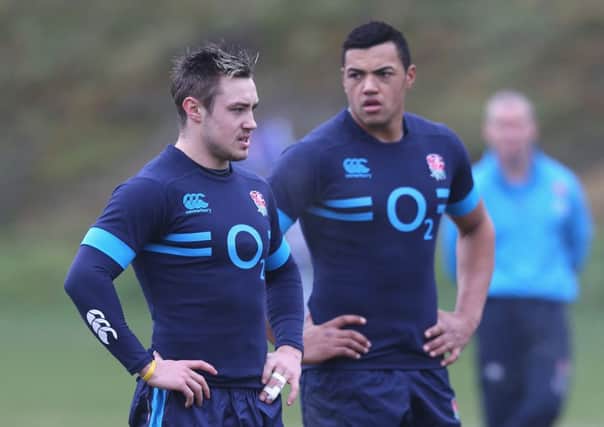 Backs Jack Nowell, left, and Luther Burrell look on during an England training session. Picture: Getty