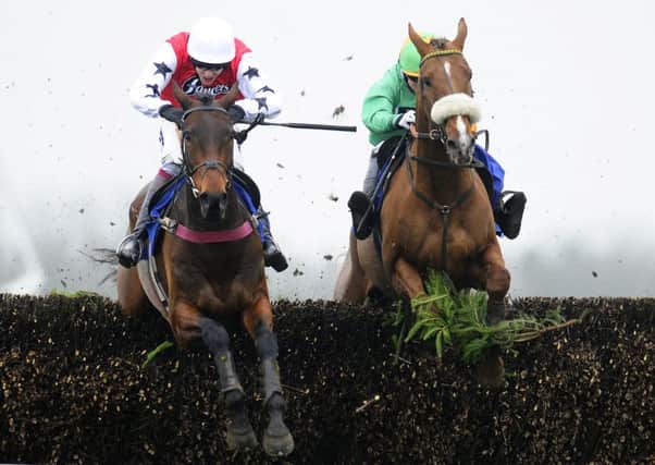 Aidan Coleman and Bennys Mist, left, clear the last to win The Dick Hunter Handicap Steeple Chase. Picture: Getty