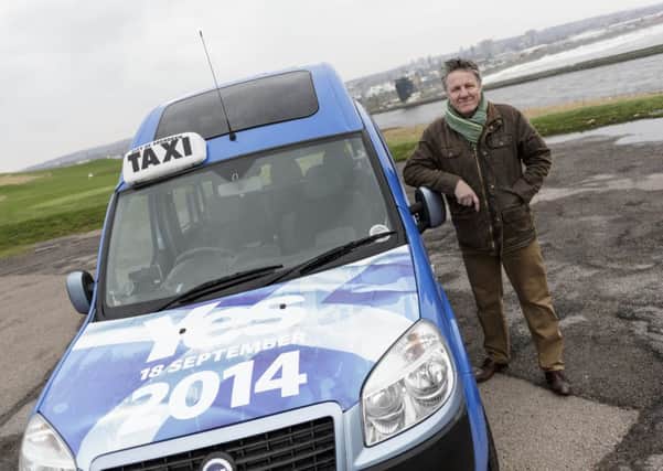Aberdeen taxi driver and supporter of Scottish independence Gordon Anderson with his taxi covered with Yes logos. Picture: Newsline