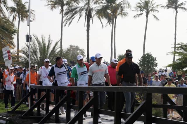 Tiger Woods leads a group including Rory McIlroy over a bridge during the second round in Dubai yesterday. Picture: Getty Images