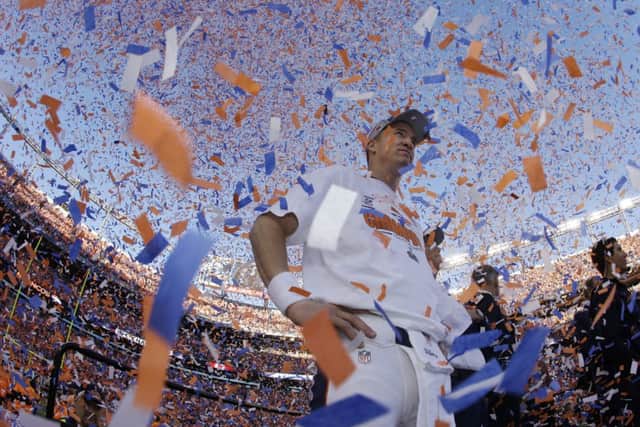 Peyton Manning surveys the field of victory after the Broncos defeated the New England Patriots 26-16 in the AFC championship game at Mile High Stadium to secure their place in tonights Super Bowl. Photograph: Charlie Riedel/AP