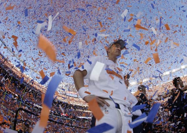 Peyton Manning surveys the field of victory after the Broncos defeated the New England Patriots 26-16 in the AFC championship game at Mile High Stadium to secure their place in tonights Super Bowl. Photograph: Charlie Riedel/AP