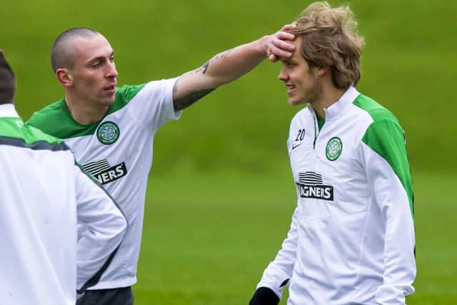 Celtic captain Scott Brown appears to be checking team-mate Teemu Pukkis temperature at training yesterday. Picture: SNS