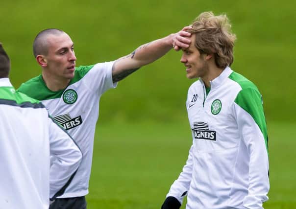 Celtic captain Scott Brown appears to be checking team-mate Teemu Pukkis temperature at training yesterday. Picture: SNS