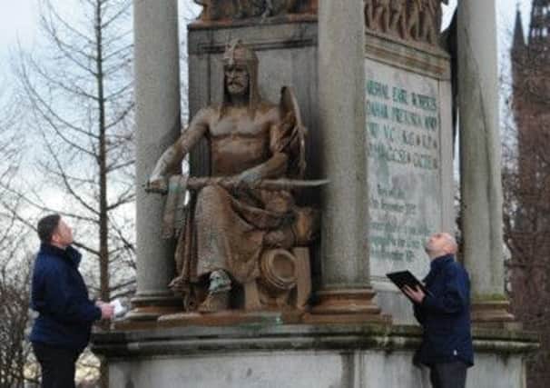 Supervisors William Holmes, left, and Chris Weightham inspect the Lord Roberts statue. Photograph: Robert Perry