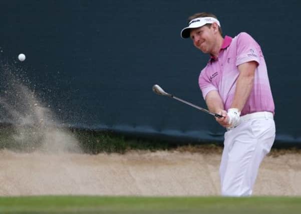 Stephen Gallacher plays out of a bunker on the 18th for yet another birdie during a record-equalling back nine that put him into the lead yesterday. Photograph: Ahmed Jadallah/Reuters