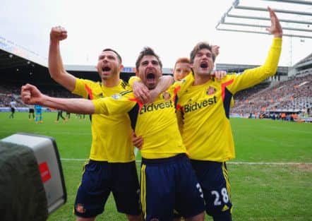 Sunderlands Fabio Borini celebrates with team-mates Phil Bardsley, left, and Marcos Alonso after his penalty. Photograph: Michael Regan