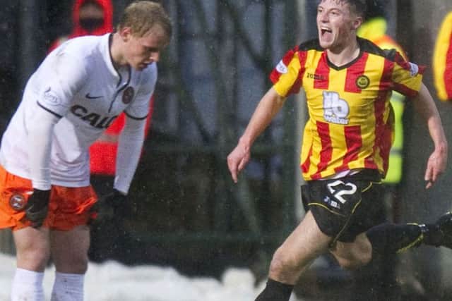 Gary Fraser races off to celebrate after equalising for Partick. Picture: SNS