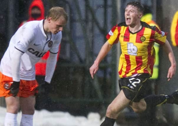 Gary Fraser races off to celebrate after equalising for Partick. Picture: SNS
