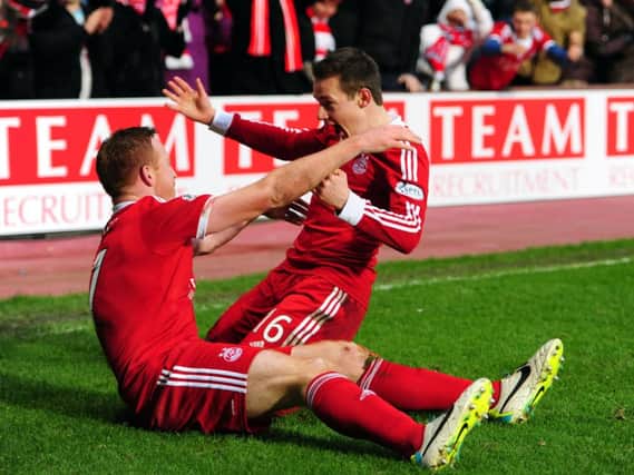 Adam Rooney celebrates with Peter Pawlett after scoring the third Aberdeen goal. Picture:Ian Rutherford
