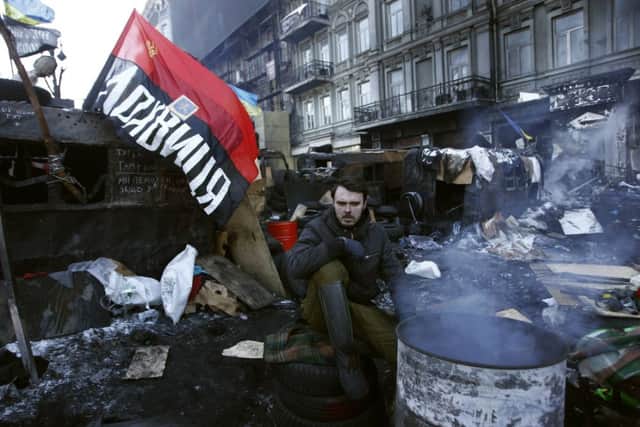 A protester mans a barricade in Kiev yesterday, despite the Arctic conditions in the city. Picture: Reuters