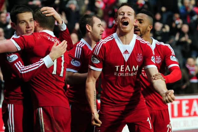 Adam Rooney celebrates after scoring Aberdeen's third goal against St Johnstone.  Picture: Ian Rutherford