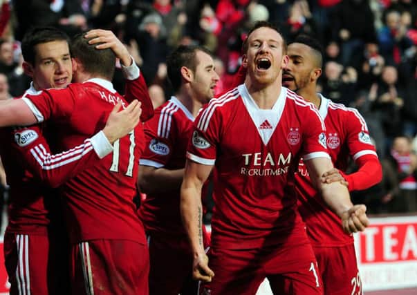 Adam Rooney celebrates after scoring Aberdeen's third goal against St Johnstone. Picture: Ian Rutherford