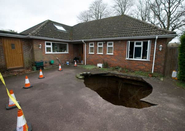 A view of the home of Phil and Liz Conran in High Wycombe, Buckinghamshire after a 30ft-deep sinkhole opened up in the driveway yesterday and swallowed their car. Picture: PA