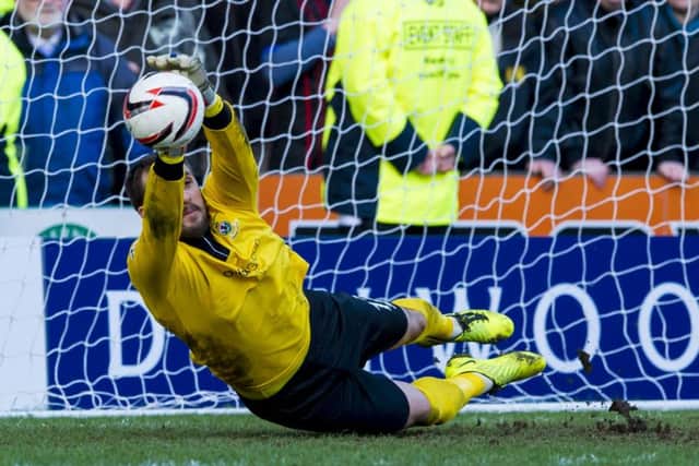 The Inverness No 1 gets down low to save Jamie Hamills effort. Picture: SNS