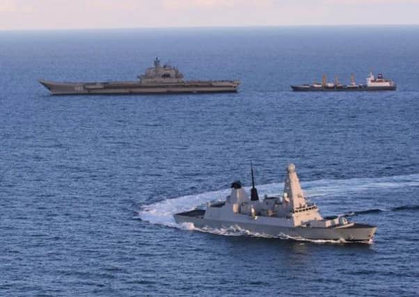HMS Defender, foreground, escorts Russian aircraft carrier Admiral Kuznetsov off the Moray coast. Picture: Contributed